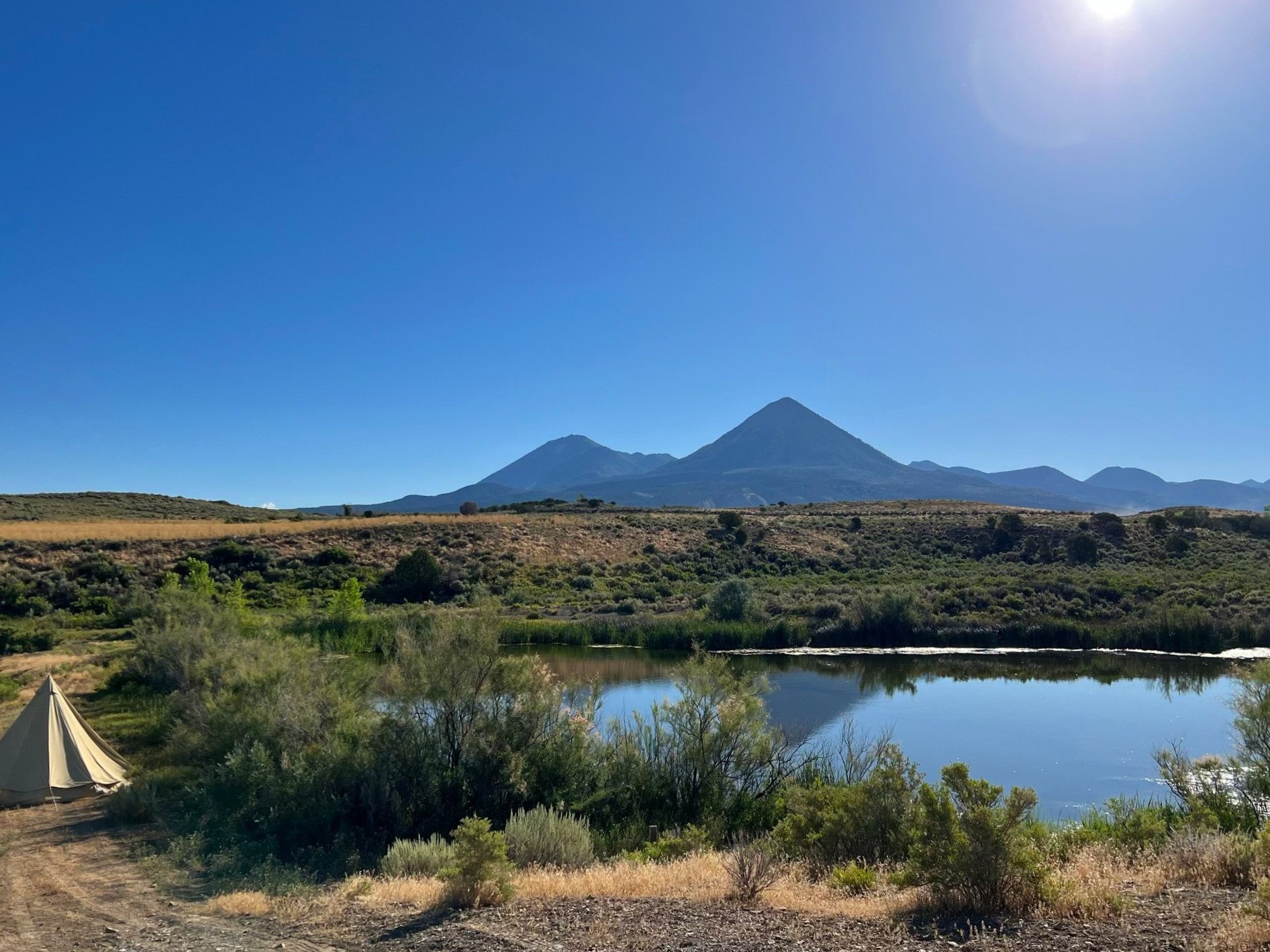 Retreat location with tent and mountain lake views